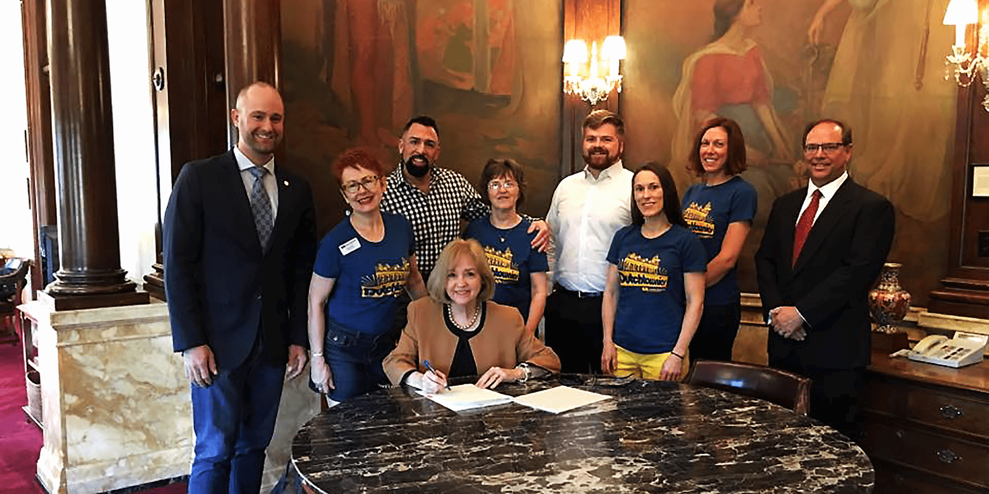 Attorney Nate Lindsey, Mayor Lyda Krewson, and other signing the Dutchtown Community Improvement District into law.