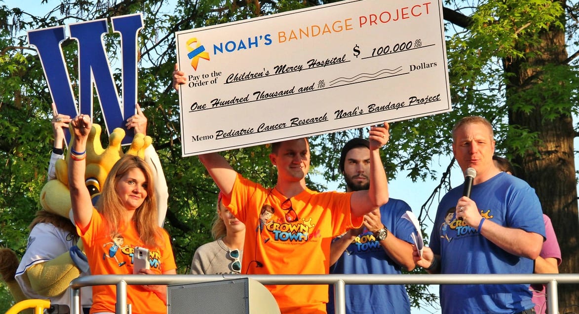 Noah's parents Scott and Deb Wilson presenting a check from Noah's Bandage Project to Children's Mercy Hospital Kansas City.