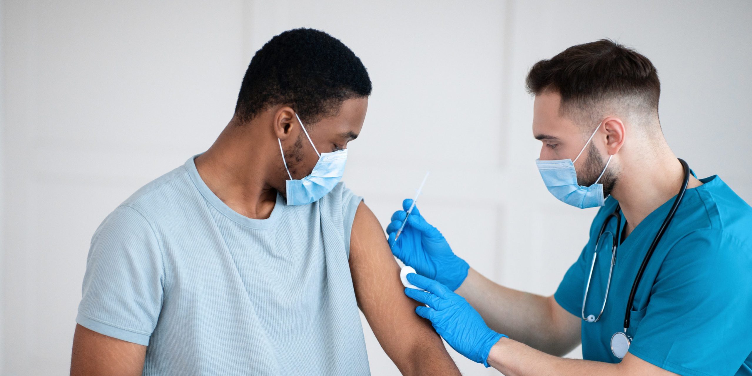 A person receiving a COVID-19 vaccination. RDM's Brandon Powell discusses employer mandated vaccinations.